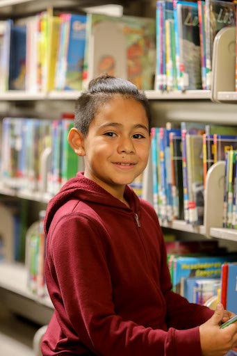 Student posing in the library